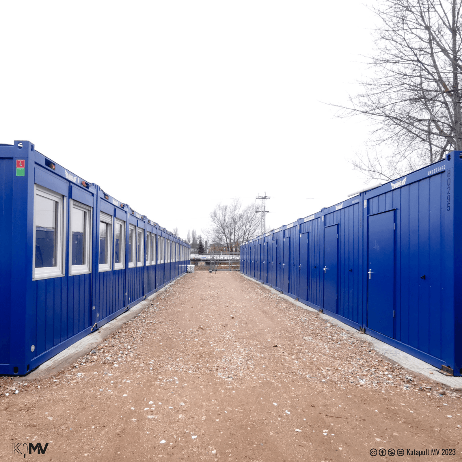 Foto von zwei gegenüberliegenden Reihen von jeweils zwölf blauen Containern