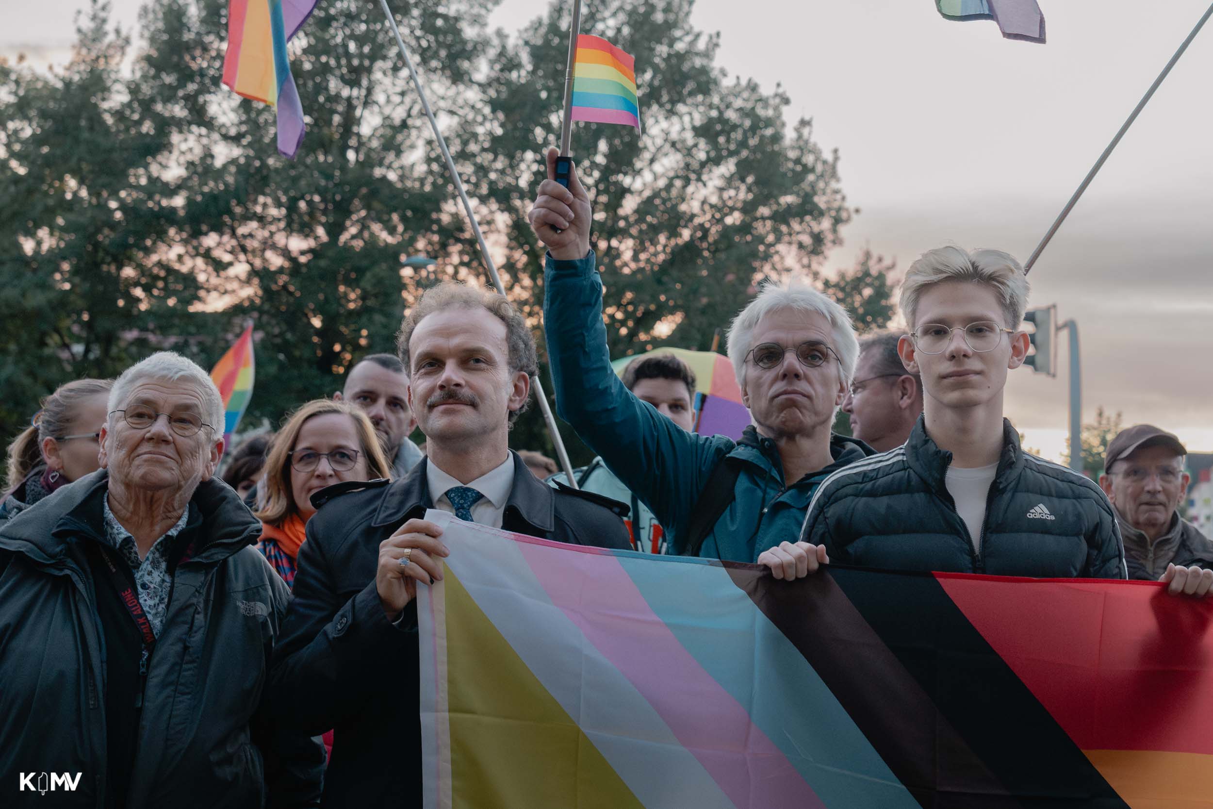 Nils Berghoff steht hinter eine Regenbogenflagge, neben ihm Oberbürgermeister Silvio Witt.